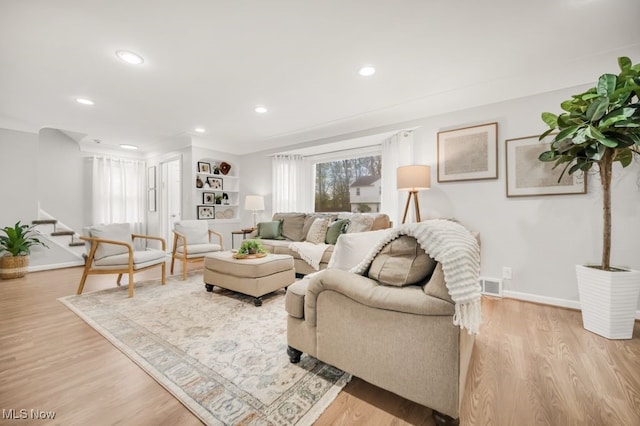 3843 Bendemeer Rd, Cleveland Heights, OH 44118 - living room with stairway, light wood-style flooring, baseboards, and recessed lighting