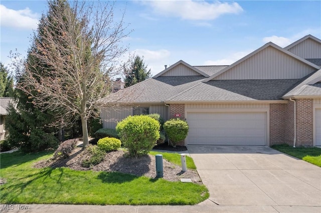 489 Paul Tell Trl, Tallmadge, OH 44278 - view of front of home featuring a garage, brick siding, a shingled roof, driveway, and a front yard