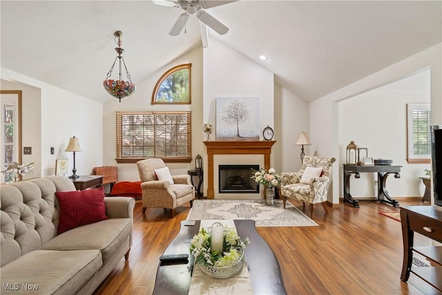 489 Paul Tell Trl, Tallmadge, OH 44278 - living room with healthy amount of natural light, wood finished floors, a fireplace, high vaulted ceiling, and a ceiling fan