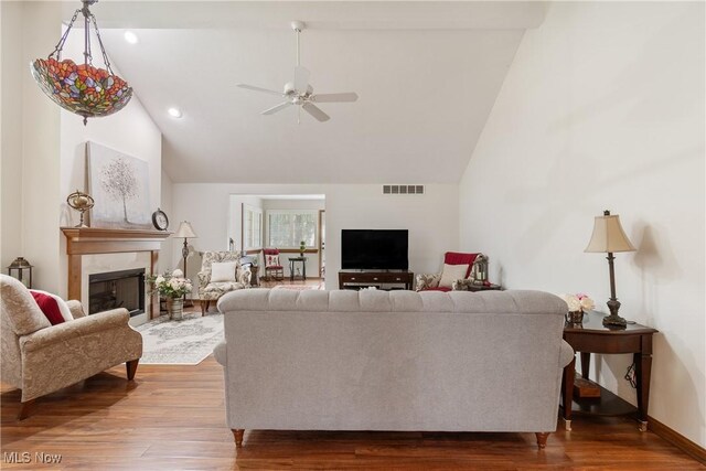489 Paul Tell Trl, Tallmadge, OH 44278 - living room featuring a fireplace, a ceiling fan, wood finished floors, high vaulted ceiling, and baseboards