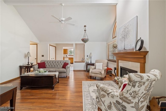 489 Paul Tell Trl, Tallmadge, OH 44278 - living room with a ceiling fan, wood finished floors, a fireplace, high vaulted ceiling, and baseboards