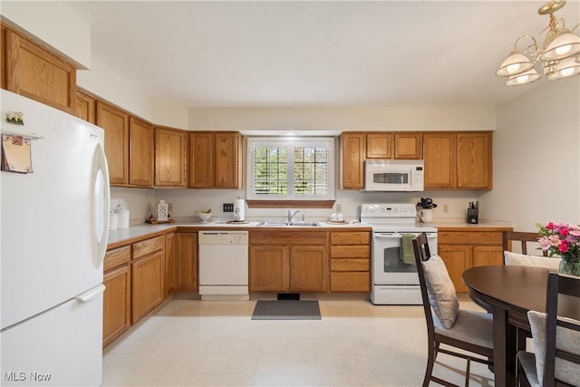 489 Paul Tell Trl, Tallmadge, OH 44278 - kitchen with white appliances, a sink, light countertops, brown cabinets, and a chandelier