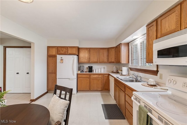 489 Paul Tell Trl, Tallmadge, OH 44278 - kitchen featuring white appliances, a sink, light countertops, and brown cabinetry