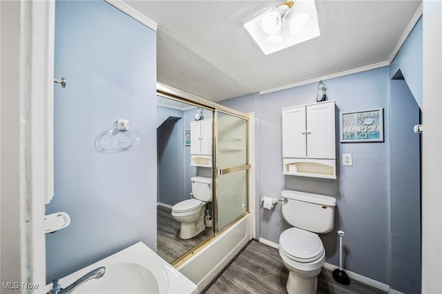 3509 Fargo Dr, Ashtabula, OH 44004 - bathroom with toilet, wood finished floors, a sink, a skylight, and baseboards