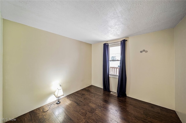 3509 Fargo Dr, Ashtabula, OH 44004 - empty room featuring dark wood finished floors and a textured ceiling