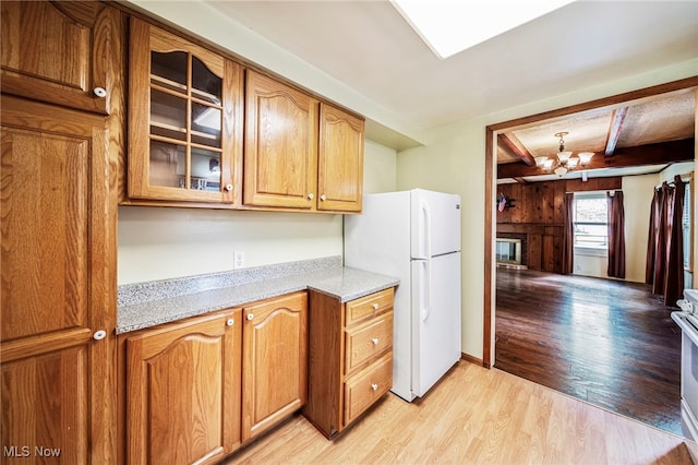 3509 Fargo Dr, Ashtabula, OH 44004 - kitchen featuring freestanding refrigerator, light wood-type flooring, a chandelier, glass insert cabinets, and brown cabinets