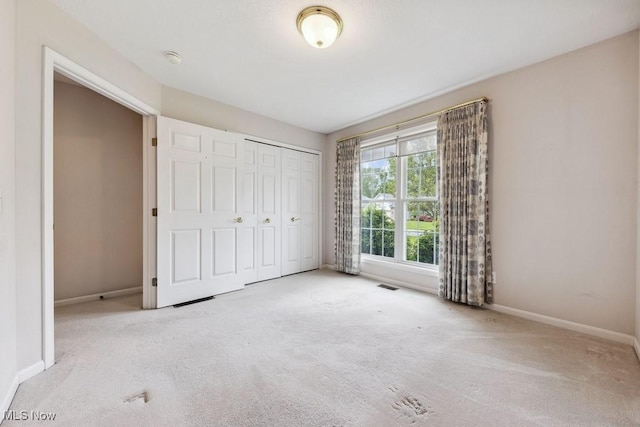1250 Spring Ridge Cir, Alliance, OH 44601 - unfurnished bedroom featuring carpet floors, baseboards, and a closet