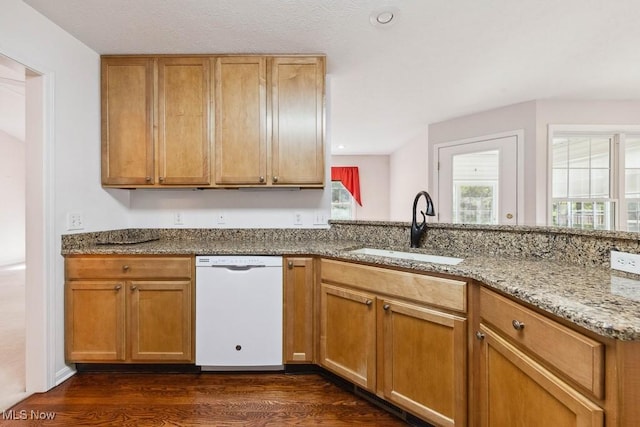 1250 Spring Ridge Cir, Alliance, OH 44601 - kitchen with white dishwasher, a sink, light stone countertops, dark wood-type flooring, and a peninsula