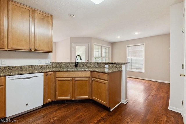 1250 Spring Ridge Cir, Alliance, OH 44601 - kitchen with dishwasher, a sink, a peninsula, dark wood-type flooring, and dark stone counters