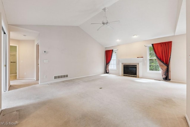 1250 Spring Ridge Cir, Alliance, OH 44601 - unfurnished living room featuring lofted ceiling, ceiling fan, carpet, a fireplace with flush hearth, and baseboards