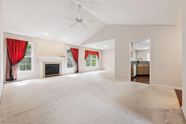 1250 Spring Ridge Cir, Alliance, OH 44601 - unfurnished living room with lofted ceiling, carpet flooring, ceiling fan, a fireplace with flush hearth, and a sink