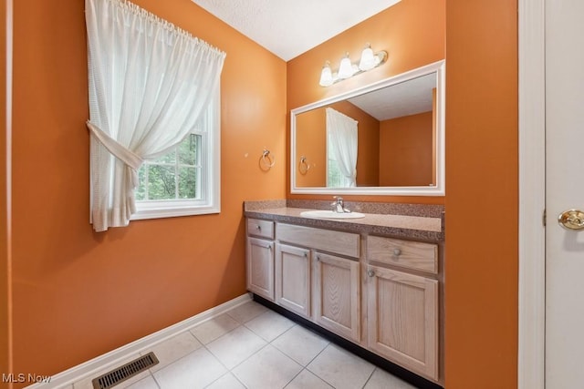1250 Spring Ridge Cir, Alliance, OH 44601 - bathroom with vanity, tile patterned flooring, and baseboards