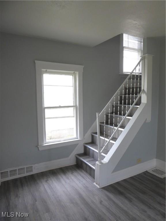 2067 W 105th St, Cleveland, OH 44102 - stairway featuring healthy amount of natural light, baseboards, and wood finished floors
