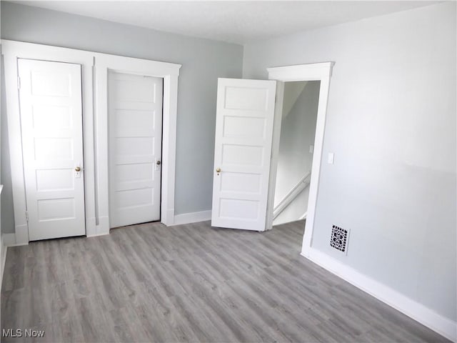2067 W 105th St, Cleveland, OH 44102 - unfurnished bedroom featuring wood finished floors and baseboards