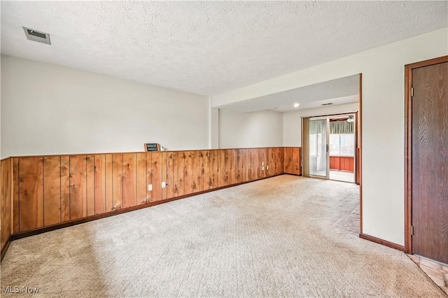 804 Cynthia Ct, Niles, OH 44446 - carpeted spare room with wainscoting, a textured ceiling, and wooden walls