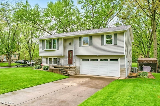 804 Cynthia Ct, Niles, OH 44446 - bi-level home featuring an attached garage, driveway, a front yard, and a shed