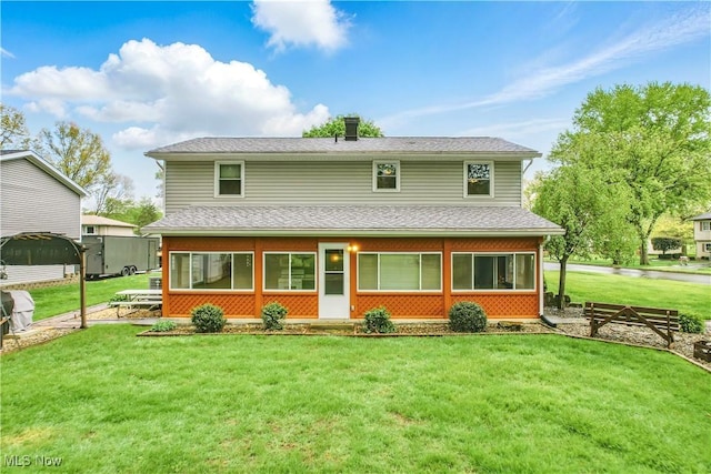 804 Cynthia Ct, Niles, OH 44446 - back of property featuring a lawn, a sunroom, and a shingled roof