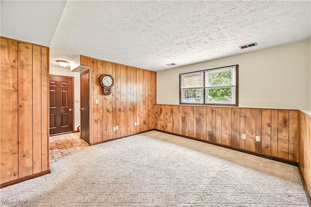 804 Cynthia Ct, Niles, OH 44446 - empty room with wood walls, a textured ceiling, baseboards, and carpet flooring