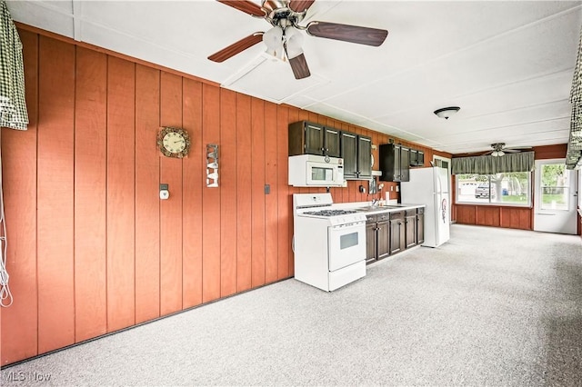 804 Cynthia Ct, Niles, OH 44446 - kitchen featuring white appliances, ceiling fan, light countertops, light colored carpet, and wooden walls