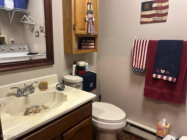 1845 Meadow Ln Unit B, Salem, OH 44460 - half bath featuring a baseboard radiator, toilet, vanity, and baseboards