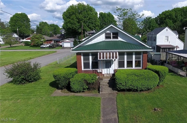 1632 Lawrence St, Parkersburg, WV 26101 - bungalow-style house featuring brick siding, metal roof, and a detached garage