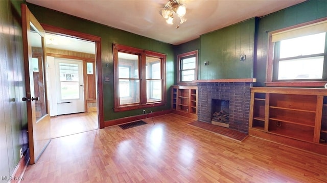 1632 Lawrence St, Parkersburg, WV 26101 - unfurnished living room with wood finished floors and a brick fireplace