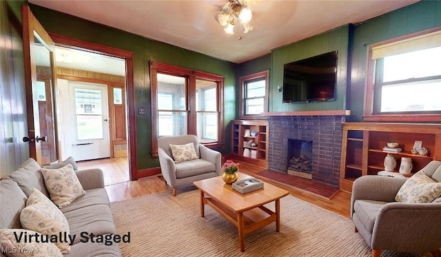 1632 Lawrence St, Parkersburg, WV 26101 - living room with wood finished floors and a brick fireplace