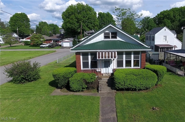 1632 Lawrence St, Parkersburg, WV 26101 - bungalow-style house featuring brick siding, metal roof, and a detached garage