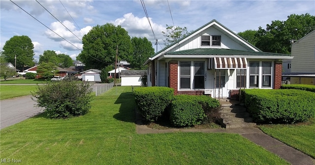 1632 Lawrence St, Parkersburg, WV 26101 - bungalow-style home featuring a front lawn, board and batten siding, brick siding, metal roof, and a standing seam roof