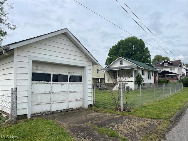 1632 Lawrence St, Parkersburg, WV 26101 - view of front facade featuring driveway, a garage, and an outdoor structure