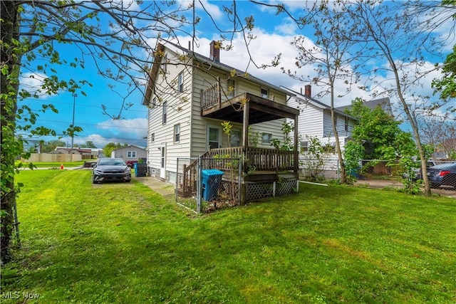 rear view of house with a chimney and a balcony