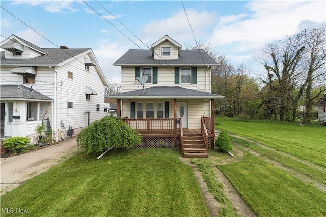 view of front of property with a porch, a front lawn, and roof with shingles
