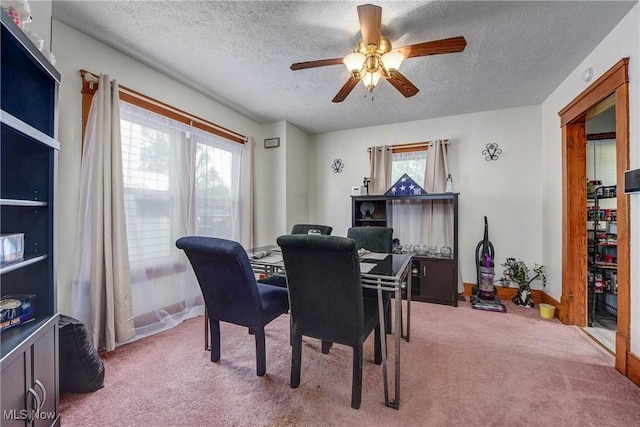 carpeted dining space featuring a textured ceiling, ceiling fan, and baseboards