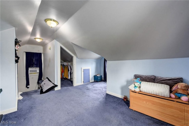 bedroom featuring carpet, vaulted ceiling, baseboards, a walk in closet, and a closet