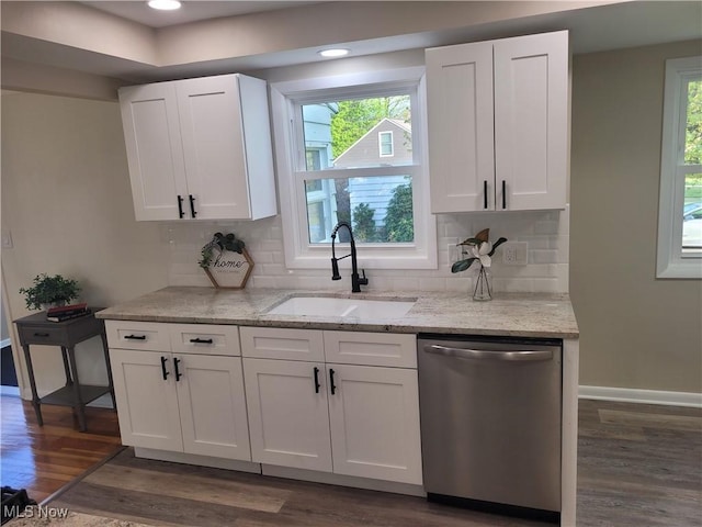 kitchen with dishwasher, a sink, dark wood-style flooring, white cabinetry, and light stone counters