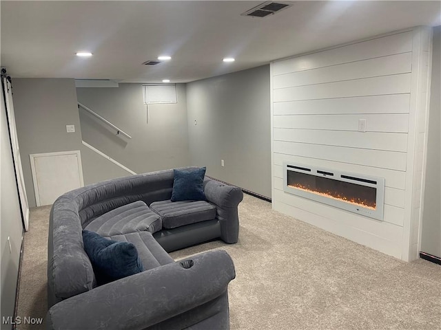carpeted living area with recessed lighting, a fireplace, and stairway