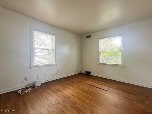 1357 Kearney St, Niles, OH 44446 - empty room with plenty of natural light, wood finished floors, and baseboards