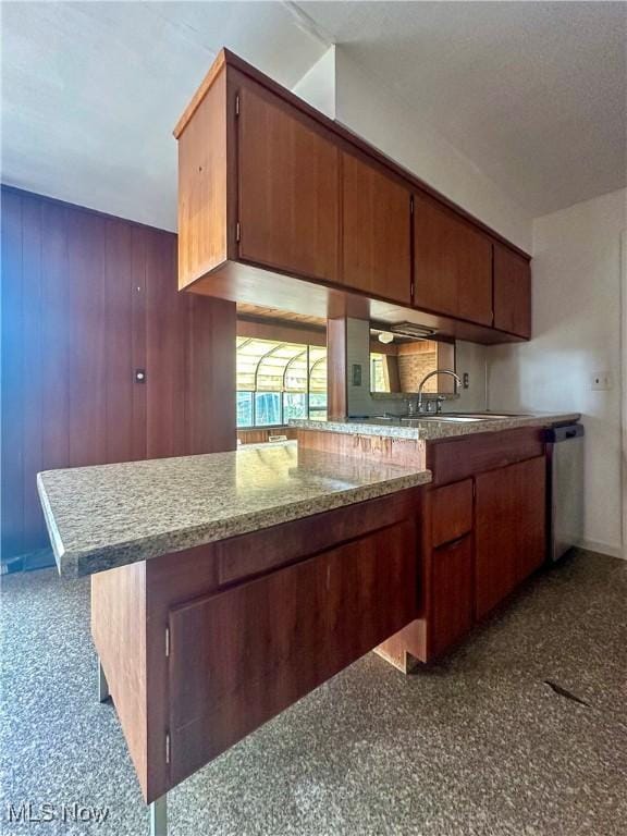 1357 Kearney St, Niles, OH 44446 - kitchen with dishwasher, a sink, and brown cabinetry