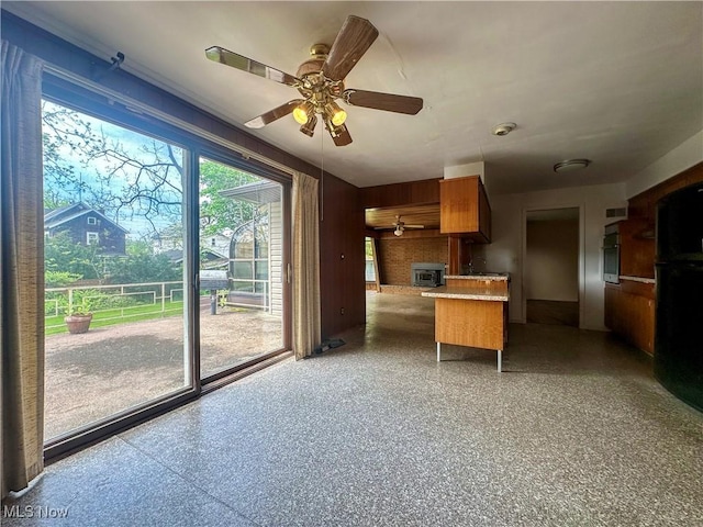1357 Kearney St, Niles, OH 44446 - kitchen featuring freestanding refrigerator, ceiling fan, stainless steel oven, brown cabinetry, and speckle patterned floor