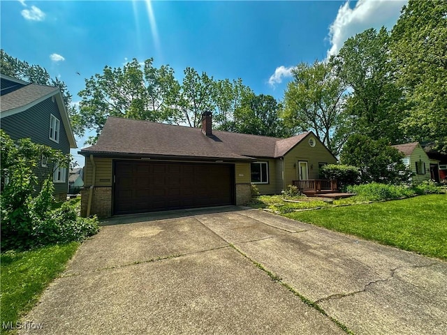 1357 Kearney St, Niles, OH 44446 - ranch-style home with a chimney, a front lawn, a garage, brick siding, and concrete driveway