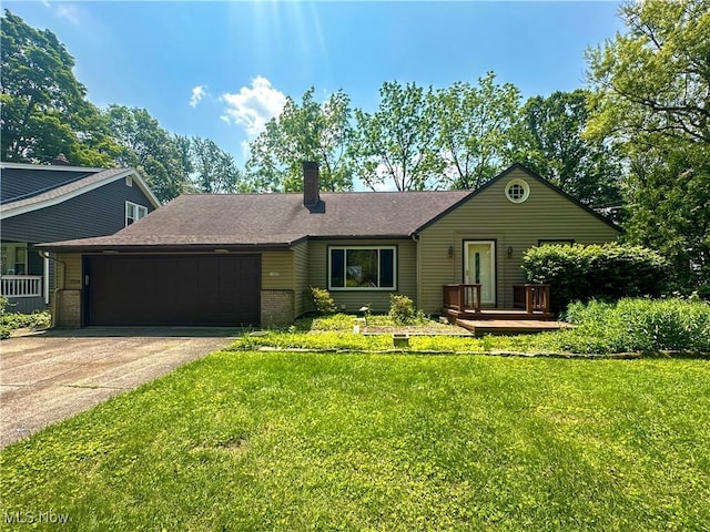 1357 Kearney St, Niles, OH 44446 - ranch-style home featuring an attached garage, concrete driveway, a chimney, and a front yard