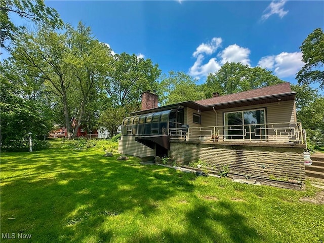 1357 Kearney St, Niles, OH 44446 - rear view of property featuring a chimney, a sunroom, and a yard