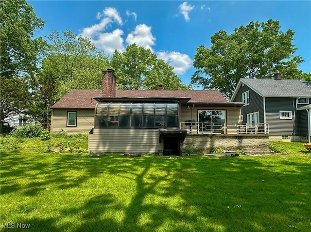 1357 Kearney St, Niles, OH 44446 - rear view of house featuring a sunroom, a lawn, a chimney, and a shingled roof