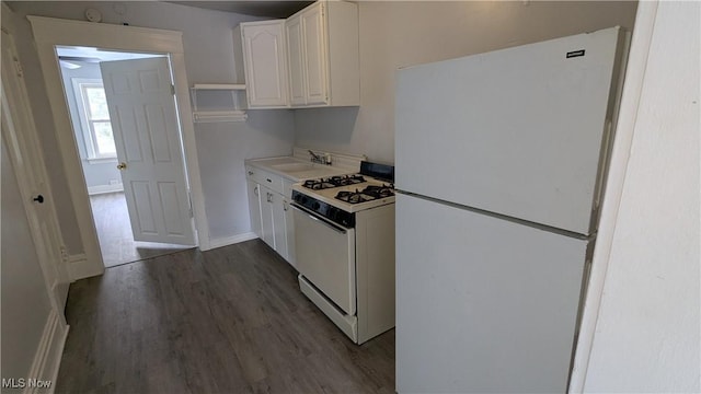 kitchen featuring white appliances, a sink, white cabinetry, dark wood-type flooring, and light countertops