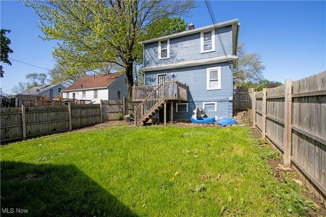 back of house with stairway, a deck, and a chimney
