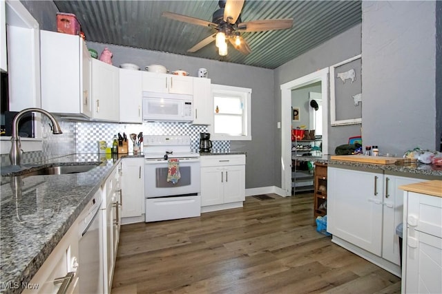 kitchen with white appliances, a sink, white cabinetry, a ceiling fan, and backsplash
