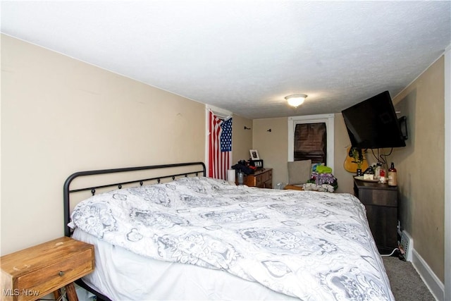 carpeted bedroom featuring baseboards