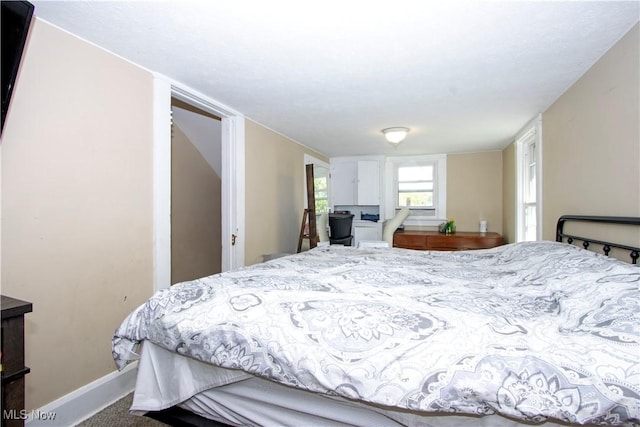 carpeted bedroom featuring baseboards