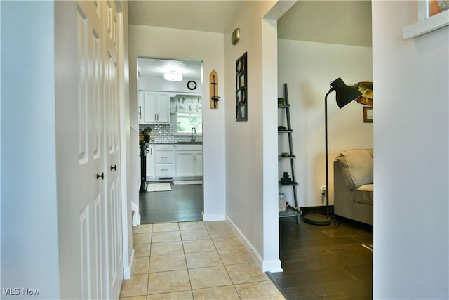 hall with light tile patterned floors and baseboards