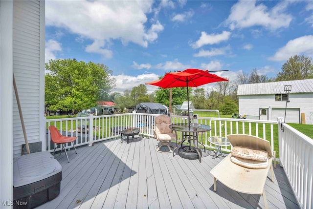 wooden terrace featuring a yard